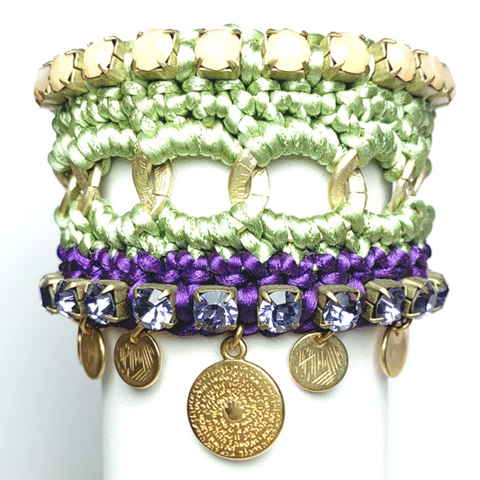 GAIA CUFF BRACELET IN GREEN AND DARK PURPLE SILK THREAD WITH BEIGE OPAQUE AND LILAC SWAROVSKI CRYSTAL CUP CHAIN DETAIL AND 24K GOLD PLATED DISC DROPS